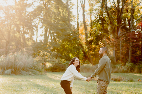 Chilly fall morning, feeling icy wind on our skin at Cross Estate Gardens for Allie and Nick’s engagement session. What we expected to be a warm morning ended up being freezing but once the sun came up the warmth followed. To warm Allie and Nick up little bit, I had them run across the field toward the sunrise, most gorgeous scene to be watching by myself. Cross Estate Gardens with it’s unique variety of backdrops it’s a photographer’s dream location really. It was so early that we were the only people there and with Allie and Nick we got to know each other and I documented their love at Cross Estate Gardens NJ. Cross Estate Gardens NJ engagement with Allie and Nick photographed by Karis from Hey Karis. Photograph is like freezing time, motion in print, movie turned into a book. 