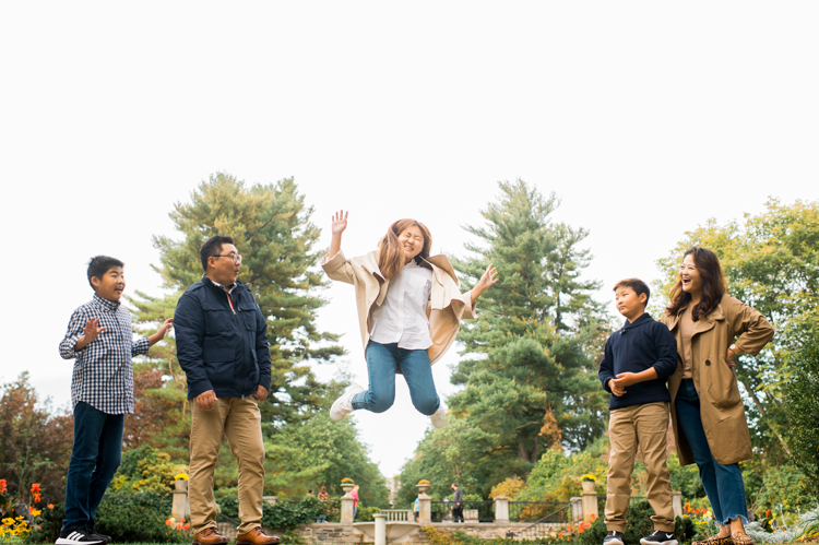 Esther and Thomas’ Fall family session at NJ Botanical Garden with three of their older children were so much to photograph since older kids tend to follow direction better. But I can not do cute little poses that I do with younger children. I thought to myself what would Wes Anderson do? Something more abstract and something fun. Bigger and older kids needed big actions and something not cheesy. Photographing older kids were bit challenging at first but I think we all had some fun and got some good photos for Esther and Thomas’ family. Esther and Thomas’ fall family session at NJ Botanical Garden photographed by Karis from Hey Karis. Photograph is like freezing time, motion in print, movie turned into a book.