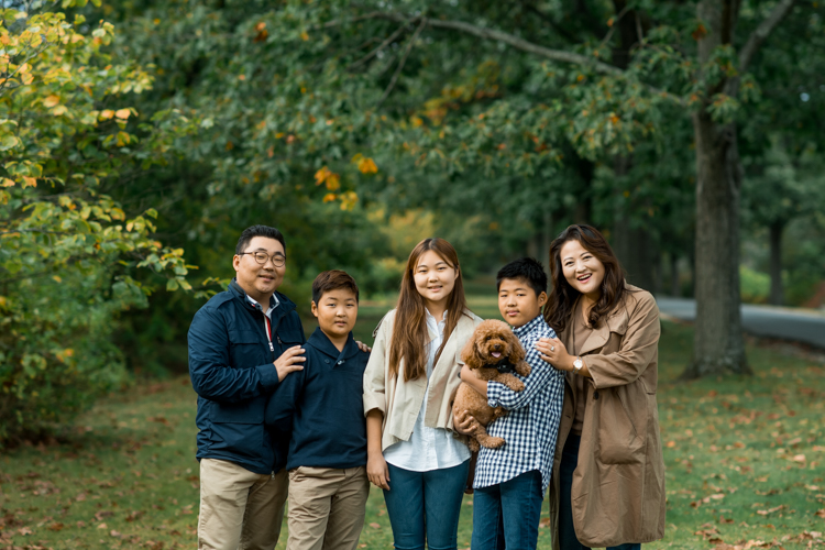 Esther and Thomas’ Fall family session at NJ Botanical Garden with three of their older children were so much to photograph since older kids tend to follow direction better. But I can not do cute little poses that I do with younger children. I thought to myself what would Wes Anderson do? Something more abstract and something fun. Bigger and older kids needed big actions and something not cheesy. Photographing older kids were bit challenging at first but I think we all had some fun and got some good photos for Esther and Thomas’ family. Esther and Thomas’ fall family session at NJ Botanical Garden photographed by Karis from Hey Karis. Photograph is like freezing time, motion in print, movie turned into a book.