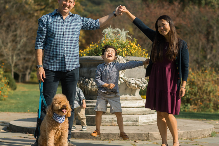 Most perfect, magical time of the year truly is Fall. Everything suddenly became golden, lovely, beautiful and good. Every sunrise and sunset is so great. We enjoyed full Fall weather with Jackie and Rob during their Fall family session at NJ Botanical Garden. Jackie and I went to Leonia High school together and it’s been over twenty years since we last met, nothing seemed different except now with our own kids and a husband. It was so great seeing old friend and her family, their shared smiles, love. A family’s chemistry is so warm, love so big and true. I sincerely love photographing family photos, I am so glad I am the person to capture this memory for them. Photograph is like freezing time, motion in print, movie turned into a book. Fall family session at NJ Botanical Garden with Jackie and Rob captured by Karis from Hey Karis.