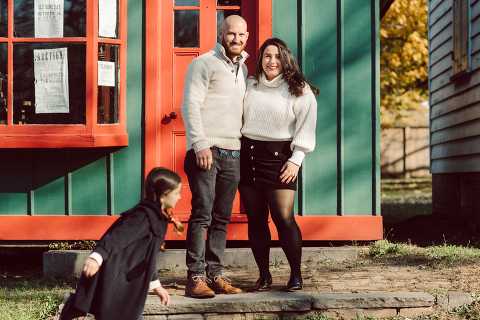 Brooke reached out to me for holiday family session and she had plans, props and we were all looking forward to Brooke and Mike’s holiday family session with their two kids Grace and Tommy at Historic Richmond Town in Staten Island NY. Brooke and Mike are from Staten Island and they did not live too far from Historic Richmond Town and they decorate the whole town pretty festive so we decide to meet there. But like all plans Brooke’s big hope for her very first professional photoshoot didn’t go as she planed. Her two kids Grace and Tommy were not having it. As soon as they got to the parking lot Tommy fell asleep. Grace was shy and scared to have her photos taken by a stranger photographer me. But we tried and got some good cute photos, and some not so cute and grumpy photos as well. Brooke, Mike, Grace and Tommy’s Historic Richmond Town Staten Island Holiday Family session documented and  photographed by Karis from Hey Karis. Photograph is like freezing time, motion in print, movie turned into a book. Now booking 2021 and 2022 weddings.