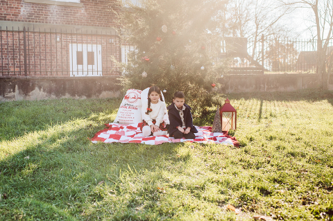 Brooke reached out to me for holiday family session and she had plans, props and we were all looking forward to Brooke and Mike’s holiday family session with their two kids Grace and Tommy at Historic Richmond Town in Staten Island NY. Brooke and Mike are from Staten Island and they did not live too far from Historic Richmond Town and they decorate the whole town pretty festive so we decide to meet there. But like all plans Brooke’s big hope for her very first professional photoshoot didn’t go as she planed. Her two kids Grace and Tommy were not having it. As soon as they got to the parking lot Tommy fell asleep. Grace was shy and scared to have her photos taken by a stranger photographer me. But we tried and got some good cute photos, and some not so cute and grumpy photos as well. Brooke, Mike, Grace and Tommy’s Historic Richmond Town Staten Island Holiday Family session documented and  photographed by Karis from Hey Karis. Photograph is like freezing time, motion in print, movie turned into a book. Now booking 2021 and 2022 weddings.