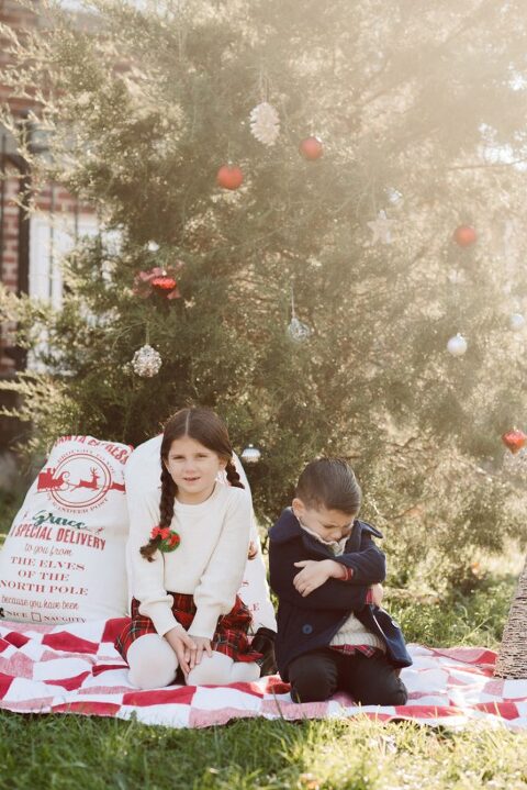 Brooke reached out to me for holiday family session and she had plans, props and we were all looking forward to Brooke and Mike’s holiday family session with their two kids Grace and Tommy at Historic Richmond Town in Staten Island NY. Brooke and Mike are from Staten Island and they did not live too far from Historic Richmond Town and they decorate the whole town pretty festive so we decide to meet there. But like all plans Brooke’s big hope for her very first professional photoshoot didn’t go as she planed. Her two kids Grace and Tommy were not having it. As soon as they got to the parking lot Tommy fell asleep. Grace was shy and scared to have her photos taken by a stranger photographer me. But we tried and got some good cute photos, and some not so cute and grumpy photos as well. Brooke, Mike, Grace and Tommy’s Historic Richmond Town Staten Island Holiday Family session documented and  photographed by Karis from Hey Karis. Photograph is like freezing time, motion in print, movie turned into a book. Now booking 2021 and 2022 weddings.