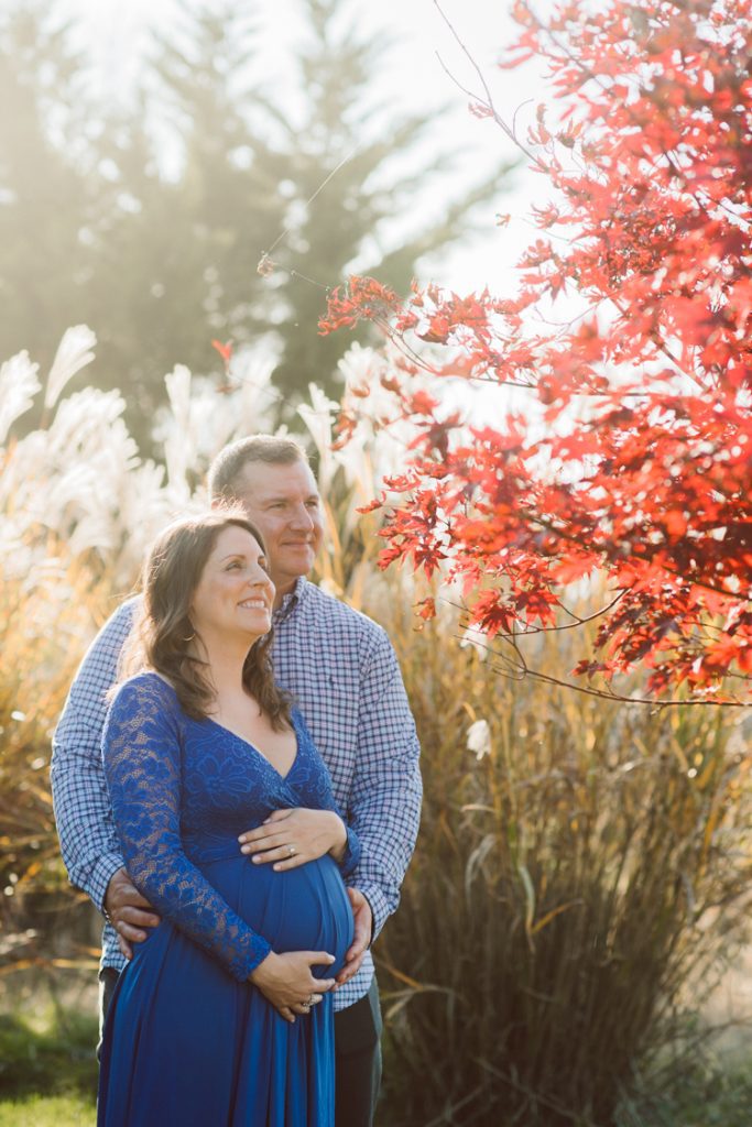 Lisa and Jamie chose to goto Ninety Acres at Natirar NJ because that’s where Jamie proposed to Lisa and had dinner. Since then Lisa and Jamie go back to Ninety Acres to celebrate their anniversary.  And we came here for Lisa and Jamie’s maternity session, a special place in their hearts and once the baby arrives as a family of three they will come celebrate their anniversary with their baby boy. Maybe because it was a special place for Lisa and Jamie, the weather was so beautiful, sunset was so glorious. Lisa and Jamie’s maternity session at Ninety Acres at Natirara NJ  photographed by Karis from Hey Karis. Photograph is like freezing time, motion in print, movie turned into a book. Now booking 2021 and 2022 weddings.