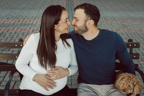 Very hot & sunny afternoon in November I met with Sam and Nick for the maternity session. This expecting parents brought their two fur babies out with them in the hopes of getting some photos of just four before the baby comes next months. Their puppies Cats and Cabo are shih-poos (shih Tzu and Toy Poodle mix) and are too adorable. With Case, Cabo walking along their parents sides we walked along the waterfront of Hoboken NJ. Sam was literally glowing like a porcelain doll and Nick looked so excited and a bit nervous for boy’s arrival. Sam and Nick’s maternity/family session in Hoboken NJ photographed by Karis from Hey Karis. Photograph is like freezing time, motion in print, movie turned into a book. Now booking 2021 and 2022 weddings.