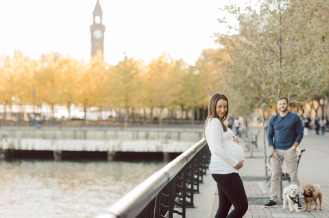 Very hot & sunny afternoon in November I met with Sam and Nick for the maternity session. This expecting parents brought their two fur babies out with them in the hopes of getting some photos of just four before the baby comes next months. Their puppies Cats and Cabo are shih-poos (shih Tzu and Toy Poodle mix) and are too adorable. With Case, Cabo walking along their parents sides we walked along the waterfront of Hoboken NJ. Sam was literally glowing like a porcelain doll and Nick looked so excited and a bit nervous for boy’s arrival. Sam and Nick’s maternity/family session in Hoboken NJ photographed by Karis from Hey Karis. Photograph is like freezing time, motion in print, movie turned into a book. Now booking 2021 and 2022 weddings.