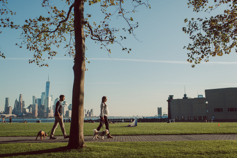 Very hot & sunny afternoon in November I met with Sam and Nick for the maternity session. This expecting parents brought their two fur babies out with them in the hopes of getting some photos of just four before the baby comes next months. Their puppies Cats and Cabo are shih-poos (shih Tzu and Toy Poodle mix) and are too adorable. With Case, Cabo walking along their parents sides we walked along the waterfront of Hoboken NJ. Sam was literally glowing like a porcelain doll and Nick looked so excited and a bit nervous for boy’s arrival. Sam and Nick’s maternity/family session in Hoboken NJ photographed by Karis from Hey Karis. Photograph is like freezing time, motion in print, movie turned into a book. Now booking 2021 and 2022 weddings.
