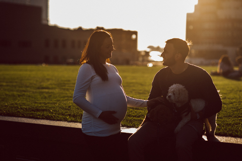 Very hot & sunny afternoon in November I met with Sam and Nick for the maternity session. This expecting parents brought their two fur babies out with them in the hopes of getting some photos of just four before the baby comes next months. Their puppies Cats and Cabo are shih-poos (shih Tzu and Toy Poodle mix) and are too adorable. With Case, Cabo walking along their parents sides we walked along the waterfront of Hoboken NJ. Sam was literally glowing like a porcelain doll and Nick looked so excited and a bit nervous for boy’s arrival. Sam and Nick’s maternity/family session in Hoboken NJ photographed by Karis from Hey Karis. Photograph is like freezing time, motion in print, movie turned into a book. Now booking 2021 and 2022 weddings.