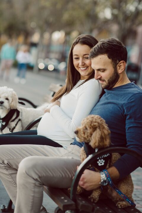 Very hot & sunny afternoon in November I met with Sam and Nick for the maternity session. This expecting parents brought their two fur babies out with them in the hopes of getting some photos of just four before the baby comes next months. Their puppies Cats and Cabo are shih-poos (shih Tzu and Toy Poodle mix) and are too adorable. With Case, Cabo walking along their parents sides we walked along the waterfront of Hoboken NJ. Sam was literally glowing like a porcelain doll and Nick looked so excited and a bit nervous for boy’s arrival. Sam and Nick’s maternity/family session in Hoboken NJ photographed by Karis from Hey Karis. Photograph is like freezing time, motion in print, movie turned into a book. Now booking 2021 and 2022 weddings.