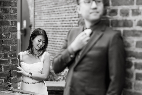 DUMBO Brooklyn NY photographing Stella and Peter's engagement. Temperature dropped dramatically, sky was covered in cloud and was windy but you can't possibly tell by Stella's chic outfit, white strap dress with white kitten heel mules and Peter in his suit and a Gucci tie. Per their outfits, my concept for Stella and Peter's engagement session geared to more editorial. As I shoot I tried to imagine a story in which I want to create and tell through my photos in every session. Stella and Peter's DUMBO Brooklyn Engagement Session captured by NY NJ Documentary Wedding Photographer Karis from Hey Karis, photographing your wedding moments cinematically.