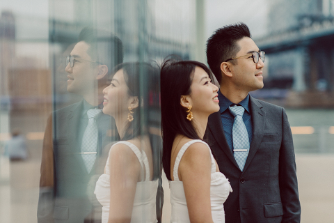 DUMBO Brooklyn NY photographing Stella and Peter's engagement. Temperature dropped dramatically, sky was covered in cloud and was windy but you can't possibly tell by Stella's chic outfit, white strap dress with white kitten heel mules and Peter in his suit and a Gucci tie. Per their outfits, my concept for Stella and Peter's engagement session geared to more editorial. As I shoot I tried to imagine a story in which I want to create and tell through my photos in every session. Stella and Peter's DUMBO Brooklyn Engagement Session captured by NY NJ Documentary Wedding Photographer Karis from Hey Karis, photographing your wedding moments cinematically.