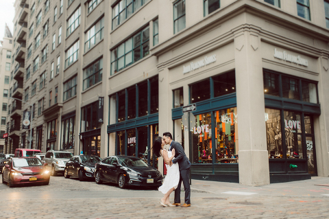 DUMBO Brooklyn NY photographing Stella and Peter's engagement. Temperature dropped dramatically, sky was covered in cloud and was windy but you can't possibly tell by Stella's chic outfit, white strap dress with white kitten heel mules and Peter in his suit and a Gucci tie. Per their outfits, my concept for Stella and Peter's engagement session geared to more editorial. As I shoot I tried to imagine a story in which I want to create and tell through my photos in every session. Stella and Peter's DUMBO Brooklyn Engagement Session captured by NY NJ Documentary Wedding Photographer Karis from Hey Karis, photographing your wedding moments cinematically.