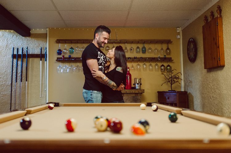 When Cristina and Nick mentioned that they want to do a day in the life, lifestyle type of engagement session at comfort of their home I was all in. What other places on earth other than your home describes you the most! You are most comfortable in your own home, and it shows in these engagement photos of Cristina and Nick that they were cozy. I sensed that Cristina and Nick were both bit shy, quiet, introverts so doing their engagement session at their home made it easier for them to open up and warm up to me. They showed me around their house, telling me stories about the electric guitars on the wall, plants, Nick's mom's snowman collections and into the basement where I saw Nick's Marvel and Super Hero collections. We took photos in all their familiar spaces around the house then out back by the fire pit where Nick had already started the fire before I came. Cristina and Nick told me that's where they love to hang out the most, fire pit with drinks in their hands, cozying up with a blanket over them. Funny story, Cristina and Nick's first date was at the house because they met in the beginning of COVID lockdown and had no where to go so Nick lite the fire pit and they had their romantic fire pit first date. And rest is history! So their engagement session at home in Wayne just made sense. Before the session was over we had to take one last photo with super hero helmet! of course Nick picks Iron Man and Cristina got stuck w Ant Man. I loved Cristina and Nick's calm vibe and getting to know them through my lens during their home engagement session captured by NY NJ Documentary Wedding Photographer Karis from Hey Karis, photographing your wedding, capturing your love and documenting your life.
