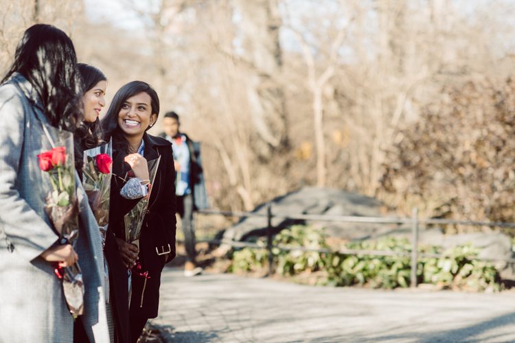 Nisha and Sagar's Ladies Pavilion Central Park NY proposal on a sunny sunday afternoon went just as Sagar planned it to be and more with their friends to celebrate together. Nisha and Sagar walked from their NYC apartment to Ladies Pavilion Central Park pretending to meet their friends for a pop up lunch but as soon as Nisha saw all her girlfriends standing by Ladies Pavilion holding roses, she quickly figured out what was about to happen. Then Sagar walked Nisha over into Ladies Pavilion where it was decorated with candles and rose pedals, Sagar went down on his one knee pulled out the ring. Watching Sagar go on his knee Nisha also went on her knee and received her ring while saying "Yes" and hugging him. All the emotions, tears hanging off her big round eyes. I truly felt so honored to be able to capture this special moment in their lives for them, documenting the beginning of their next chapter in life. Nisha and Sagar's Ladies Pavilion Central Park proposal captured by NY NJ Documentary Wedding Photographer Karis from Hey Karis, photographing your wedding, capturing your love and documenting your life.