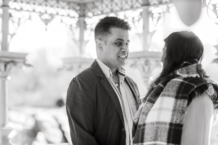 Nisha and Sagar's Ladies Pavilion Central Park NY proposal on a sunny sunday afternoon went just as Sagar planned it to be and more with their friends to celebrate together. Nisha and Sagar walked from their NYC apartment to Ladies Pavilion Central Park pretending to meet their friends for a pop up lunch but as soon as Nisha saw all her girlfriends standing by Ladies Pavilion holding roses, she quickly figured out what was about to happen. Then Sagar walked Nisha over into Ladies Pavilion where it was decorated with candles and rose pedals, Sagar went down on his one knee pulled out the ring. Watching Sagar go on his knee Nisha also went on her knee and received her ring while saying "Yes" and hugging him. All the emotions, tears hanging off her big round eyes. I truly felt so honored to be able to capture this special moment in their lives for them, documenting the beginning of their next chapter in life. Nisha and Sagar's Ladies Pavilion Central Park proposal captured by NY NJ Documentary Wedding Photographer Karis from Hey Karis, photographing your wedding, capturing your love and documenting your life.
