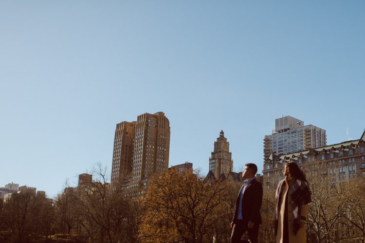 Nisha and Sagar's Ladies Pavilion Central Park NY proposal on a sunny sunday afternoon went just as Sagar planned it to be and more with their friends to celebrate together. Nisha and Sagar walked from their NYC apartment to Ladies Pavilion Central Park pretending to meet their friends for a pop up lunch but as soon as Nisha saw all her girlfriends standing by Ladies Pavilion holding roses, she quickly figured out what was about to happen. Then Sagar walked Nisha over into Ladies Pavilion where it was decorated with candles and rose pedals, Sagar went down on his one knee pulled out the ring. Watching Sagar go on his knee Nisha also went on her knee and received her ring while saying "Yes" and hugging him. All the emotions, tears hanging off her big round eyes. I truly felt so honored to be able to capture this special moment in their lives for them, documenting the beginning of their next chapter in life. Nisha and Sagar's Ladies Pavilion Central Park proposal captured by NY NJ Documentary Wedding Photographer Karis from Hey Karis, photographing your wedding, capturing your love and documenting your life.