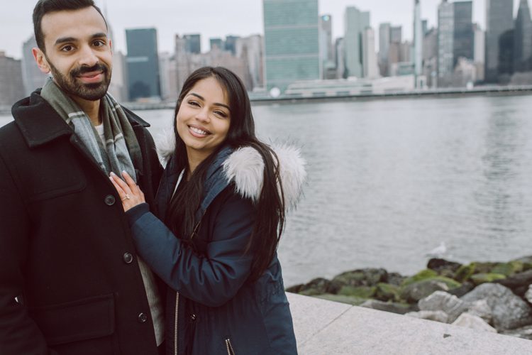Gantry Plaza State Park LIC, Jay proposed to his girlfriend Aditi the day before valentines day on February 13, 2021 and coldest day! Aditi and Jay met during school while they were studying for MBA at NYU. Proposal totally caught Aditi by surprise, Jay fell on one knee on the edge of Gantry Plaza State Park LIC pulled out the most beautiful diamond ring. With excitement and over joyed hearts, as fiancés we waked around Gantry Plaza State Park to Queens Public Library for quick portraits of the lovers before sending them away for their engagement celebration. Aditi and Jay's Gantry Plaza State Park LIC proposal photograph captured by Hey Karis documenting elopements and weddings in NY NJ and planet earth.