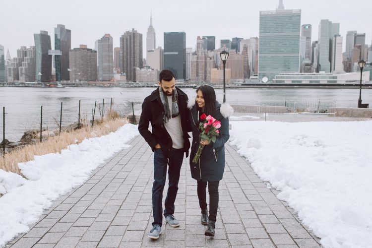 Gantry Plaza State Park LIC, Jay proposed to his girlfriend Aditi the day before valentines day on February 13, 2021 and coldest day! Aditi and Jay met during school while they were studying for MBA at NYU. Proposal totally caught Aditi by surprise, Jay fell on one knee on the edge of Gantry Plaza State Park LIC pulled out the most beautiful diamond ring. With excitement and over joyed hearts, as fiancés we waked around Gantry Plaza State Park to Queens Public Library for quick portraits of the lovers before sending them away for their engagement celebration. Aditi and Jay's Gantry Plaza State Park LIC proposal photograph captured by Hey Karis documenting elopements and weddings in NY NJ and planet earth.