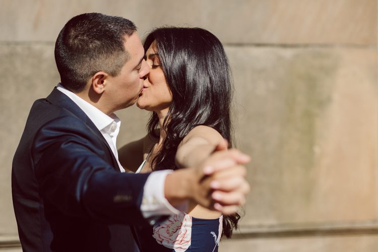 Bethesda Terrace Arcade in Central Park NY in my opinion alway so lovely. I saw Brianna and Joe standing in the middle of Bethesda Terrace next to the fountain. We walked right into the crowd of Central Park and started our engagement session. Cherry Blossoms were still in bloom along with all the spring blooms. Spring sun was brilliant and smiles on Brianna and Joe during the engagement session was so beautiful. Brianna and Joe's Bethesda Terrace Arcade in Central Park NY engagement session captured by NY NJ Weddings, Elopements and Family Photographer Karis.