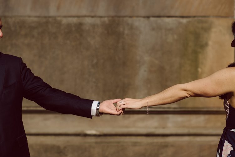 Bethesda Terrace Arcade in Central Park NY in my opinion alway so lovely. I saw Brianna and Joe standing in the middle of Bethesda Terrace next to the fountain. We walked right into the crowd of Central Park and started our engagement session. Cherry Blossoms were still in bloom along with all the spring blooms. Spring sun was brilliant and smiles on Brianna and Joe during the engagement session was so beautiful. Brianna and Joe's Bethesda Terrace Arcade in Central Park NY engagement session captured by NY NJ Weddings, Elopements and Family Photographer Karis.