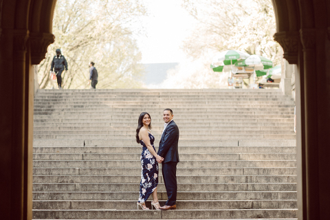 Bethesda Terrace Arcade in Central Park NY in my opinion alway so lovely. I saw Brianna and Joe standing in the middle of Bethesda Terrace next to the fountain. We walked right into the crowd of Central Park and started our engagement session. Cherry Blossoms were still in bloom along with all the spring blooms. Spring sun was brilliant and smiles on Brianna and Joe during the engagement session was so beautiful. Brianna and Joe's Bethesda Terrace Arcade in Central Park NY engagement session captured by NY NJ Weddings, Elopements and Family Photographer Karis.
