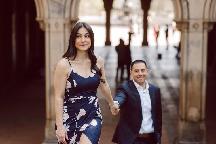 Bethesda Terrace Arcade in Central Park NY in my opinion alway so lovely. I saw Brianna and Joe standing in the middle of Bethesda Terrace next to the fountain. We walked right into the crowd of Central Park and started our engagement session. Cherry Blossoms were still in bloom along with all the spring blooms. Spring sun was brilliant and smiles on Brianna and Joe during the engagement session was so beautiful. Brianna and Joe's Bethesda Terrace Arcade in Central Park NY engagement session captured by NY NJ Weddings, Elopements and Family Photographer Karis.