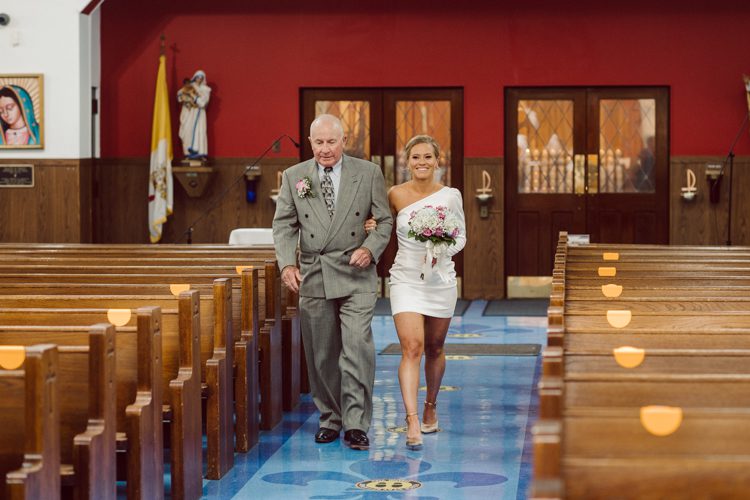 Colleen and Patrick had an intimate wedding ceremony at their church in Queens, NY then we went over to Gantry Plaza State Park LIC for their wedding photos. Colleen and Patrick's NYC elopement was nothing but fabulous and spectacle. When I saw all the food trucks lined up along Gantry Plaza State Park I knew I wanted to use it as our backdrop for Colleen and Patrick. Of course we chose "Mr Softee's Ice Truck" and as we were taking the photo one of Colleen and Patrick's cousin walked by doing the most epic photobomb ever! Colleen and Patrick's NYC elopement Gantry Plaza State Park LIC captured by NY NJ Weddings, Elopements and Family Photographer Karis by Hey Karis.