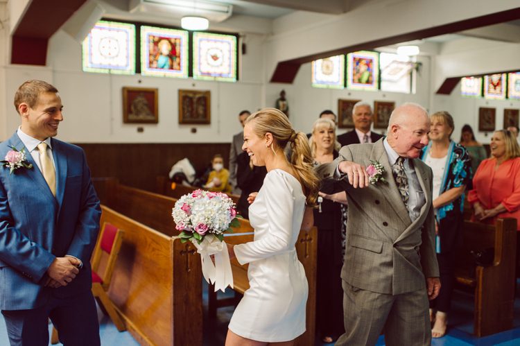 Colleen and Patrick had an intimate wedding ceremony at their church in Queens, NY then we went over to Gantry Plaza State Park LIC for their wedding photos. Colleen and Patrick's NYC elopement was nothing but fabulous and spectacle. When I saw all the food trucks lined up along Gantry Plaza State Park I knew I wanted to use it as our backdrop for Colleen and Patrick. Of course we chose "Mr Softee's Ice Truck" and as we were taking the photo one of Colleen and Patrick's cousin walked by doing the most epic photobomb ever! Colleen and Patrick's NYC elopement Gantry Plaza State Park LIC captured by NY NJ Weddings, Elopements and Family Photographer Karis by Hey Karis.