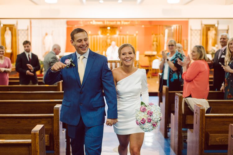 Colleen and Patrick had an intimate wedding ceremony at their church in Queens, NY then we went over to Gantry Plaza State Park LIC for their wedding photos. Colleen and Patrick's NYC elopement was nothing but fabulous and spectacle. When I saw all the food trucks lined up along Gantry Plaza State Park I knew I wanted to use it as our backdrop for Colleen and Patrick. Of course we chose "Mr Softee's Ice Truck" and as we were taking the photo one of Colleen and Patrick's cousin walked by doing the most epic photobomb ever! Colleen and Patrick's NYC elopement Gantry Plaza State Park LIC captured by NY NJ Weddings, Elopements and Family Photographer Karis by Hey Karis.