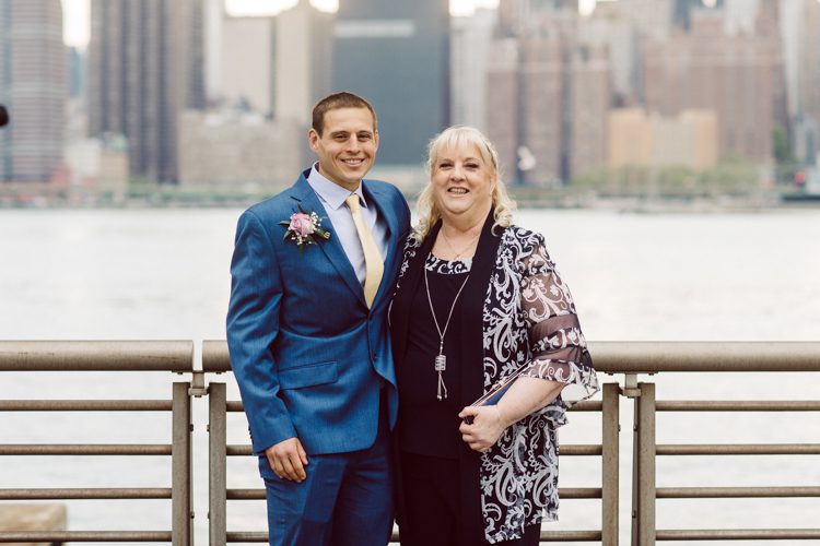 Colleen and Patrick had an intimate wedding ceremony at their church in Queens, NY then we went over to Gantry Plaza State Park LIC for their wedding photos. Colleen and Patrick's NYC elopement was nothing but fabulous and spectacle. When I saw all the food trucks lined up along Gantry Plaza State Park I knew I wanted to use it as our backdrop for Colleen and Patrick. Of course we chose "Mr Softee's Ice Truck" and as we were taking the photo one of Colleen and Patrick's cousin walked by doing the most epic photobomb ever! Colleen and Patrick's NYC elopement Gantry Plaza State Park LIC captured by NY NJ Weddings, Elopements and Family Photographer Karis by Hey Karis.