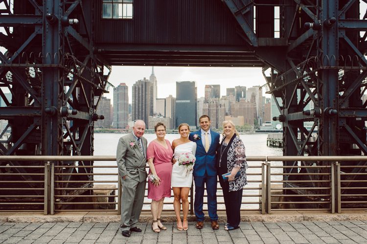 Colleen and Patrick had an intimate wedding ceremony at their church in Queens, NY then we went over to Gantry Plaza State Park LIC for their wedding photos. Colleen and Patrick's NYC elopement was nothing but fabulous and spectacle. When I saw all the food trucks lined up along Gantry Plaza State Park I knew I wanted to use it as our backdrop for Colleen and Patrick. Of course we chose "Mr Softee's Ice Truck" and as we were taking the photo one of Colleen and Patrick's cousin walked by doing the most epic photobomb ever! Colleen and Patrick's NYC elopement Gantry Plaza State Park LIC captured by NY NJ Weddings, Elopements and Family Photographer Karis by Hey Karis.