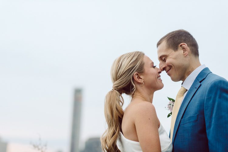 Colleen and Patrick had an intimate wedding ceremony at their church in Queens, NY then we went over to Gantry Plaza State Park LIC for their wedding photos. Colleen and Patrick's NYC elopement was nothing but fabulous and spectacle. When I saw all the food trucks lined up along Gantry Plaza State Park I knew I wanted to use it as our backdrop for Colleen and Patrick. Of course we chose "Mr Softee's Ice Truck" and as we were taking the photo one of Colleen and Patrick's cousin walked by doing the most epic photobomb ever! Colleen and Patrick's NYC elopement Gantry Plaza State Park LIC captured by NY NJ Weddings, Elopements and Family Photographer Karis by Hey Karis.