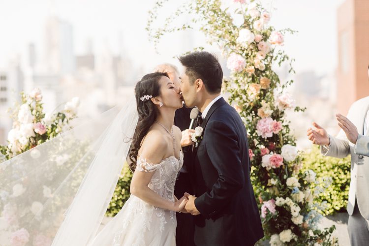 Public Hotel NYC spring rooftop wedding with Stella and Peter. NYC began to loosen COVID restrictions so events and weddings were finally allowed. Stella and Peter were able to keep their original wedding date, but unfortunately Stella's parents couldn't make it to the wedding due to COVID travel restrictions. Stella and Peter's wedding took place on 17th floor with rooftop access at the Public Hotel. Their wedding ceremony was on the rooftop, as well as their first look and some photos then we wandered around the hotel and took some epic photos at the pent house and escalator. Public Hotel NYC was so fun to photograph and I had the coolest, the most chill couple to work with. Stella and Peter's epic wedding at Public Hotel NYC photographed by Karis | Hey Karis.