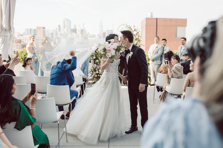 Public Hotel NYC spring rooftop wedding with Stella and Peter. NYC began to loosen COVID restrictions so events and weddings were finally allowed. Stella and Peter were able to keep their original wedding date, but unfortunately Stella's parents couldn't make it to the wedding due to COVID travel restrictions. Stella and Peter's wedding took place on 17th floor with rooftop access at the Public Hotel. Their wedding ceremony was on the rooftop, as well as their first look and some photos then we wandered around the hotel and took some epic photos at the pent house and escalator. Public Hotel NYC was so fun to photograph and I had the coolest, the most chill couple to work with. Stella and Peter's epic wedding at Public Hotel NYC photographed by Karis | Hey Karis.