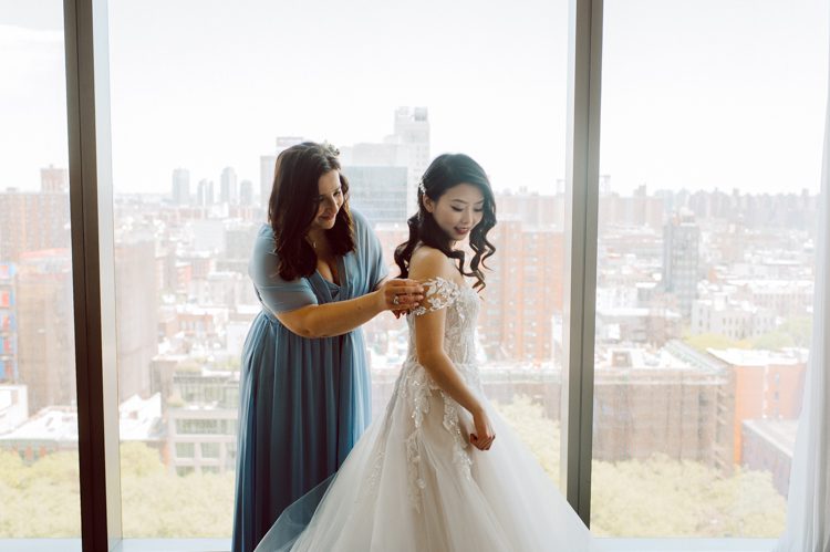 Public Hotel NYC spring rooftop wedding with Stella and Peter. NYC began to loosen COVID restrictions so events and weddings were finally allowed. Stella and Peter were able to keep their original wedding date, but unfortunately Stella's parents couldn't make it to the wedding due to COVID travel restrictions. Stella and Peter's wedding took place on 17th floor with rooftop access at the Public Hotel. Their wedding ceremony was on the rooftop, as well as their first look and some photos then we wandered around the hotel and took some epic photos at the pent house and escalator. Public Hotel NYC was so fun to photograph and I had the coolest, the most chill couple to work with. Stella and Peter's epic wedding at Public Hotel NYC photographed by Karis | Hey Karis.