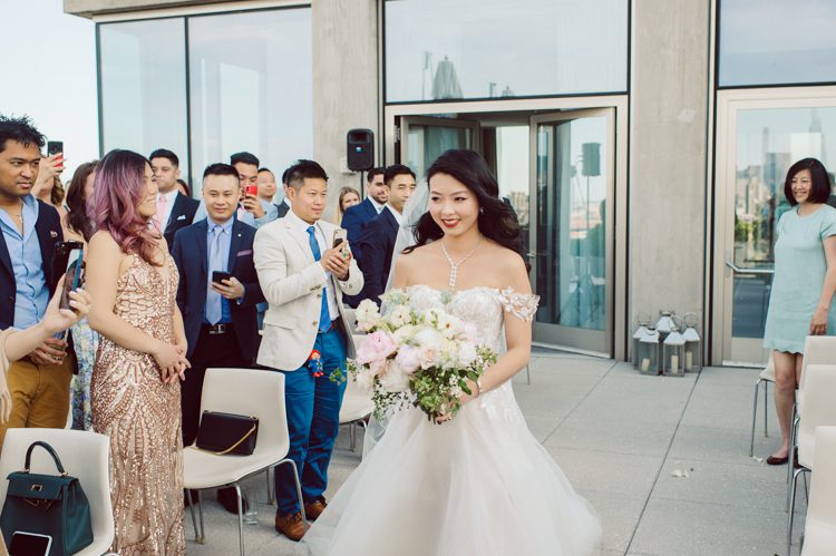 Public Hotel NYC spring rooftop wedding with Stella and Peter. NYC began to loosen COVID restrictions so events and weddings were finally allowed. Stella and Peter were able to keep their original wedding date, but unfortunately Stella's parents couldn't make it to the wedding due to COVID travel restrictions. Stella and Peter's wedding took place on 17th floor with rooftop access at the Public Hotel. Their wedding ceremony was on the rooftop, as well as their first look and some photos then we wandered around the hotel and took some epic photos at the pent house and escalator. Public Hotel NYC was so fun to photograph and I had the coolest, the most chill couple to work with. Stella and Peter's epic wedding at Public Hotel NYC photographed by Karis | Hey Karis.