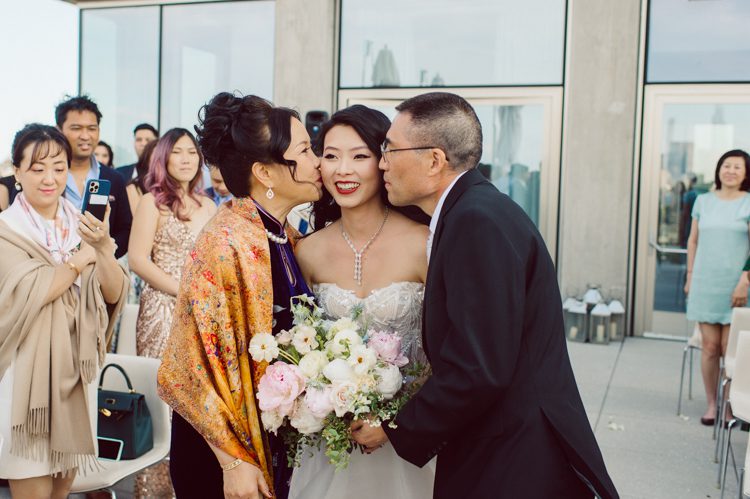 Public Hotel NYC spring rooftop wedding with Stella and Peter. NYC began to loosen COVID restrictions so events and weddings were finally allowed. Stella and Peter were able to keep their original wedding date, but unfortunately Stella's parents couldn't make it to the wedding due to COVID travel restrictions. Stella and Peter's wedding took place on 17th floor with rooftop access at the Public Hotel. Their wedding ceremony was on the rooftop, as well as their first look and some photos then we wandered around the hotel and took some epic photos at the pent house and escalator. Public Hotel NYC was so fun to photograph and I had the coolest, the most chill couple to work with. Stella and Peter's epic wedding at Public Hotel NYC photographed by Karis | Hey Karis.