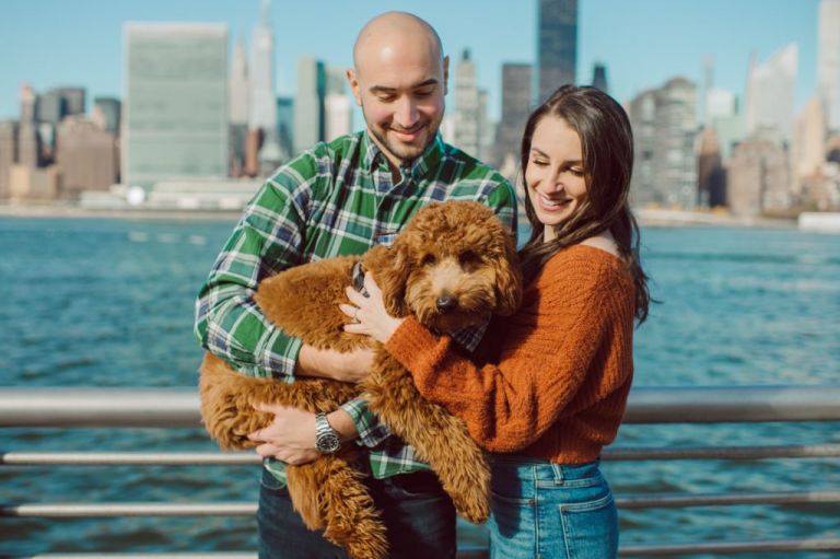The fun I had meeting Wilson, Melanie and Calvin's Golden Doodle pup I had the pleasure of meeting for their engagement session at Gantry Plaza State Park LIC. Melanie and Calvin lives right by the Gantry Plaza State Park so naturally we chose to meet here for their engagement session, plus we had to make it easy for their fur baby Wilson to join. Wilson of course stole all my attention for the first half of the engagement session then Wilson was walked by Melanie and Calvin's friend while we wandered off the explore other parts of Gantry Plaza State Park. Melanie and Calvin's Fall engagement session at Gantry Plaza State Park LIC joined by their golden doodle Wilson photographed by Hudson Valley, Catskills, NYC and NJ, Fun Weddings and Intimate Elopements Photographer | Hey Karis.