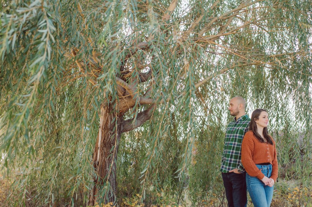 The fun I had meeting Wilson, Melanie and Calvin's Golden Doodle pup I had the pleasure of meeting for their engagement session at Gantry Plaza State Park LIC. Melanie and Calvin lives right by the Gantry Plaza State Park so naturally we chose to meet here for their engagement session, plus we had to make it easy for their fur baby Wilson to join. Wilson of course stole all my attention for the first half of the engagement session then Wilson was walked by Melanie and Calvin's friend while we wandered off the explore other parts of Gantry Plaza State Park. Melanie and Calvin's Fall engagement session at Gantry Plaza State Park LIC joined by their golden doodle Wilson photographed by Hudson Valley, Catskills, NYC and NJ, Fun Weddings and Intimate Elopements Photographer | Hey Karis.
