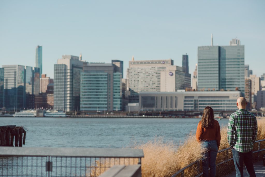The fun I had meeting Wilson, Melanie and Calvin's Golden Doodle pup I had the pleasure of meeting for their engagement session at Gantry Plaza State Park LIC. Melanie and Calvin lives right by the Gantry Plaza State Park so naturally we chose to meet here for their engagement session, plus we had to make it easy for their fur baby Wilson to join. Wilson of course stole all my attention for the first half of the engagement session then Wilson was walked by Melanie and Calvin's friend while we wandered off the explore other parts of Gantry Plaza State Park. Melanie and Calvin's Fall engagement session at Gantry Plaza State Park LIC joined by their golden doodle Wilson photographed by Hudson Valley, Catskills, NYC and NJ, Fun Weddings and Intimate Elopements Photographer | Hey Karis.