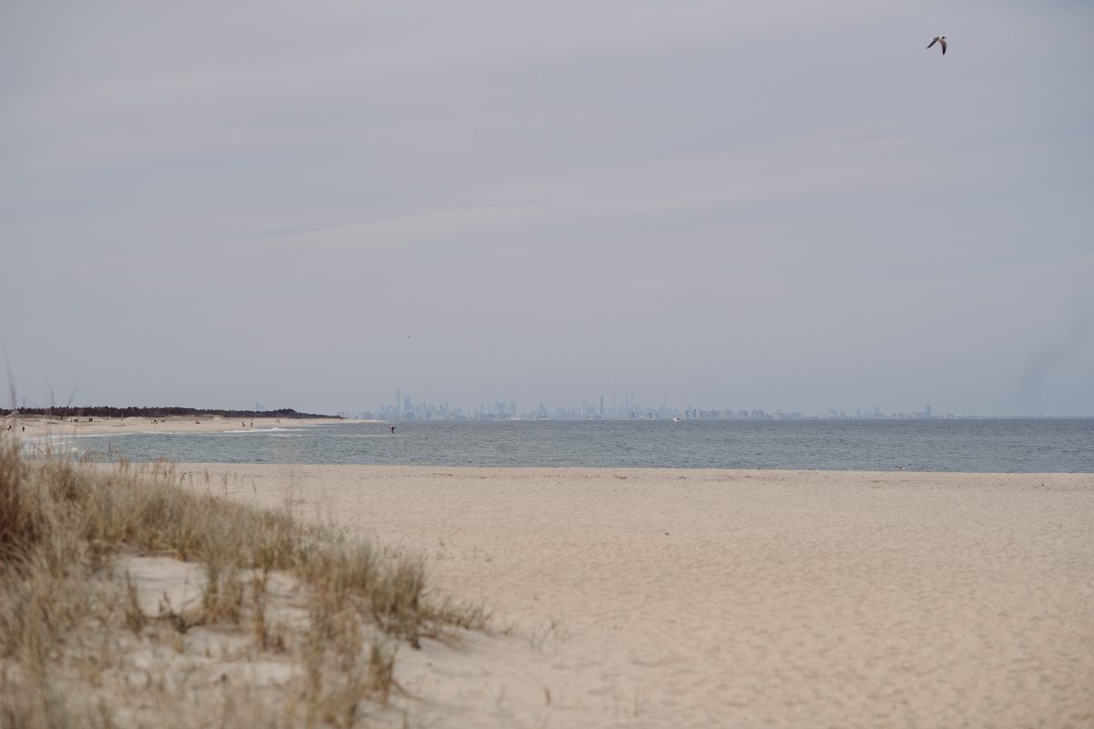 Perfect day would look like this, I said admiring the beach, the landscape and the amazing colors that I was looking out in the horizon. Sky, sea, sand looked as if they were painted in pastel blues, beige, and white. Wind moved, hair dancing, it was going to be fabulous engagement session with Becca and Dan! I fell in love with Sandy Hook Beach, and loved my awesome clients that follows all my weird, silly and sometime awkward directions/posing. My favorite out of Becca and Dan's Sandy Hook engagement session is the one that I got inspired by Wes Anderson's movie "Moonlight Kingdom"! Becca and Dan's Sandy Hook Beach NJ engagement by Karis. Hey Karis is Hudson Valley, Garrison NY and NJ, Fun Weddings and Intimate Elopements Photographer.