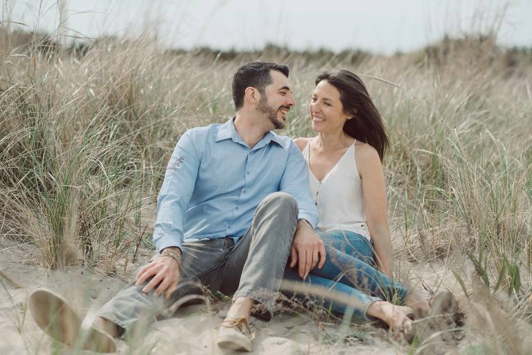 Perfect day would look like this, I said admiring the beach, the landscape and the amazing colors that I was looking out in the horizon. Sky, sea, sand looked as if they were painted in pastel blues, beige, and white. Wind moved, hair dancing, it was going to be fabulous engagement session with Becca and Dan! I fell in love with Sandy Hook Beach, and loved my awesome clients that follows all my weird, silly and sometime awkward directions/posing. My favorite out of Becca and Dan's Sandy Hook engagement session is the one that I got inspired by Wes Anderson's movie "Moonlight Kingdom"! Becca and Dan's Sandy Hook Beach NJ engagement by Karis. Hey Karis is Hudson Valley, Garrison NY and NJ, Fun Weddings and Intimate Elopements Photographer.