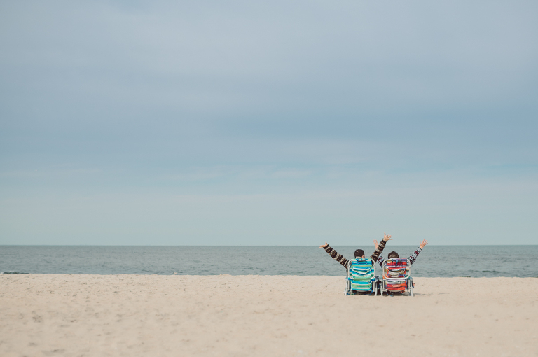 Perfect day would look like this, I said admiring the beach, the landscape and the amazing colors that I was looking out in the horizon. Sky, sea, sand looked as if they were painted in pastel blues, beige, and white. Wind moved, hair dancing, it was going to be fabulous engagement session with Becca and Dan! I fell in love with Sandy Hook Beach, and loved my awesome clients that follows all my weird, silly and sometime awkward directions/posing. My favorite out of Becca and Dan's Sandy Hook engagement session is the one that I got inspired by Wes Anderson's movie "Moonlight Kingdom"! Becca and Dan's Sandy Hook Beach NJ engagement by Karis. Hey Karis is Hudson Valley, Garrison NY and NJ, Fun Weddings and Intimate Elopements Photographer.