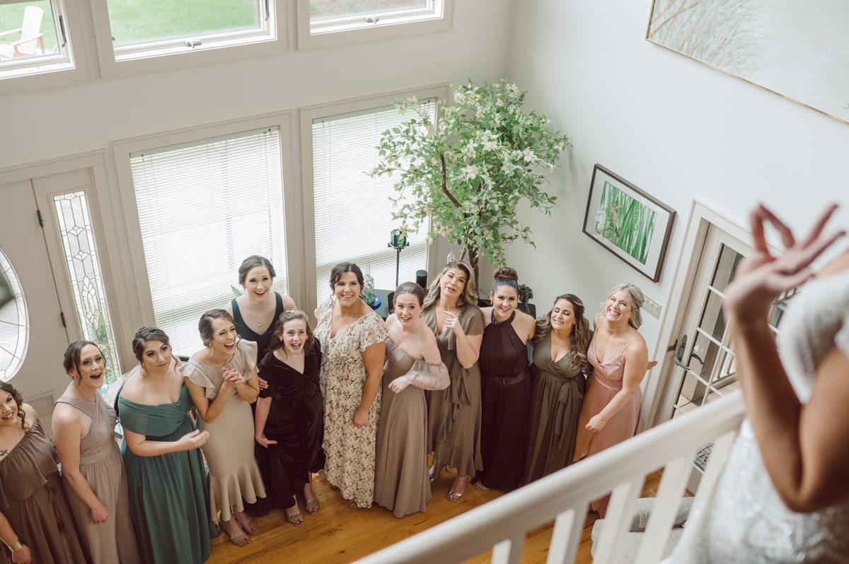 Pulled up to Michell's parents gorgeous mid-century home in Cold Spring, NY on Michelle and Robert's wedding day.  And Robert got ready at an airbnb nearby in Peekskill, NY. Even-though Michelle and Robert had some hiccup with their limo the whole village pulled together and transported Michell and Roberts along with their bridal party to the church Our Lady of Loretto Church to get Michelle and Robert married. Then everyone hoped onto everyone's cars to make their way to West Hills Country Club to party. Michelle and Robert weren't too into taking formal posed portraits but instead wanted to join their friends and guests to enjoy their wedding day, to party, to mingle, to drink and eat the food. Many candid moments were captured, and we wrapped the evening with the most stunning sunset across the field at West Hills Country Club. Michelle and Robert's West Hills Country Club Wedding captured by Hey Karis is NY, NJ, Brooklyn, Hudson Valley and Catskills Wedding and Elopement Photographer.