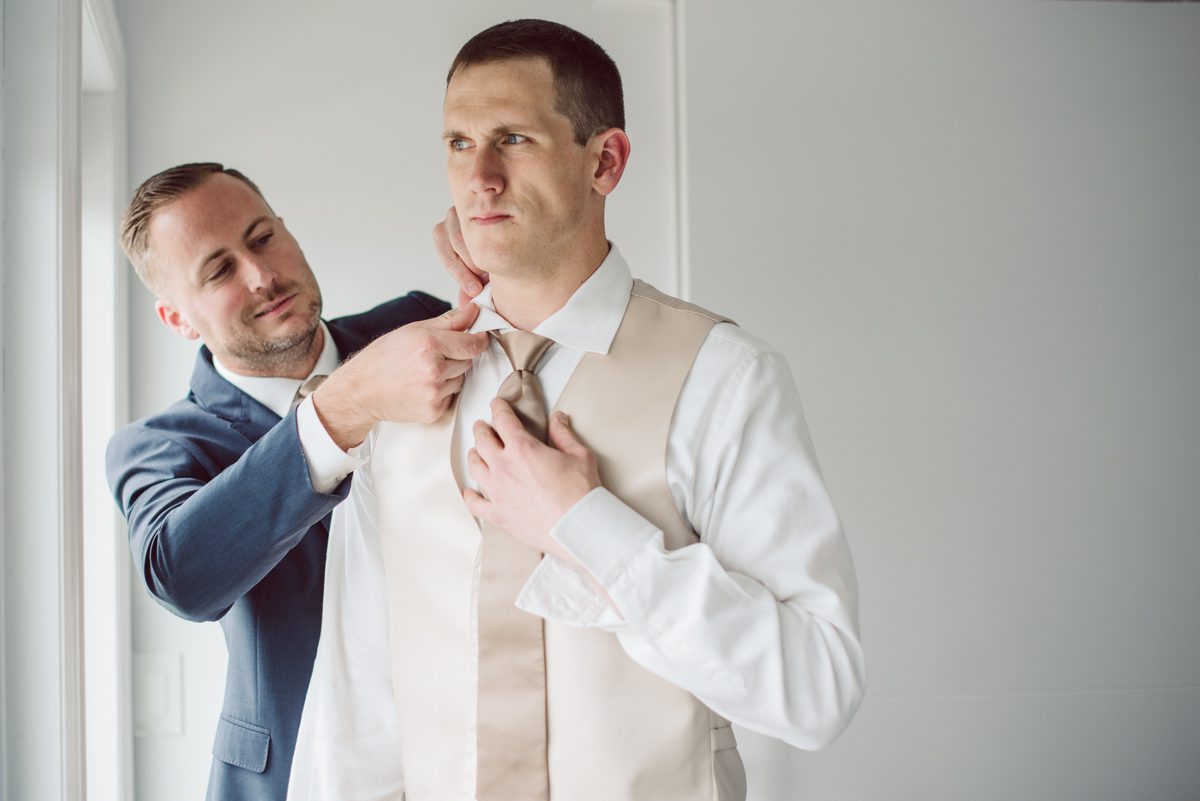 Pulled up to Michell's parents gorgeous mid-century home in Cold Spring, NY on Michelle and Robert's wedding day.  And Robert got ready at an airbnb nearby in Peekskill, NY. Even-though Michelle and Robert had some hiccup with their limo the whole village pulled together and transported Michell and Roberts along with their bridal party to the church Our Lady of Loretto Church to get Michelle and Robert married. Then everyone hoped onto everyone's cars to make their way to West Hills Country Club to party. Michelle and Robert weren't too into taking formal posed portraits but instead wanted to join their friends and guests to enjoy their wedding day, to party, to mingle, to drink and eat the food. Many candid moments were captured, and we wrapped the evening with the most stunning sunset across the field at West Hills Country Club. Michelle and Robert's West Hills Country Club Wedding captured by Hey Karis is NY, NJ, Brooklyn, Hudson Valley and Catskills Wedding and Elopement Photographer.