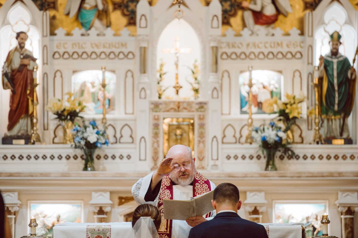 Pulled up to Michell's parents gorgeous mid-century home in Cold Spring, NY on Michelle and Robert's wedding day.  And Robert got ready at an airbnb nearby in Peekskill, NY. Even-though Michelle and Robert had some hiccup with their limo the whole village pulled together and transported Michell and Roberts along with their bridal party to the church Our Lady of Loretto Church to get Michelle and Robert married. Then everyone hoped onto everyone's cars to make their way to West Hills Country Club to party. Michelle and Robert weren't too into taking formal posed portraits but instead wanted to join their friends and guests to enjoy their wedding day, to party, to mingle, to drink and eat the food. Many candid moments were captured, and we wrapped the evening with the most stunning sunset across the field at West Hills Country Club. Michelle and Robert's West Hills Country Club Wedding captured by Hey Karis is NY, NJ, Brooklyn, Hudson Valley and Catskills Wedding and Elopement Photographer.