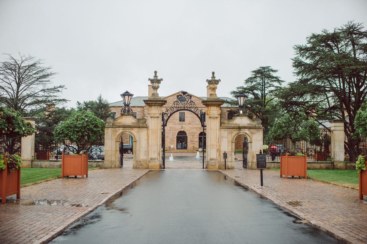 In beautiful Princeton, NJ sits Jasna Polana. This unique wedding venue which is part of TPC Jasna Polana Country Club with it's Tuscany like exterior with cobble stone circular entry way with ground fountain. You'll feel like a royal family when you get married here. It was raining on Hillary and Will's wedding day, so we didn't get to explore the grounds as much as we would have like to but this brave bride Hillary was willing to go out into the rain for outdoor photos on her wedding day. Incredible colors with all the greens, white flowers from the back garden, Hillary's white wedding dress created such a romantic contrast against the deep greens, blues it was such a incredible day. I had such a fun time capturing Hillary and Will on their wedding day at Jasna Polana and can not wait to come back to this gorgeous venue on a dry day to capture more moments. Hillary and Will's Jasna Polana Princeton NJ wedding  captured by Karis from Hey Karis NY, NJ, Brooklyn, Hudson Valley and Catskills Wedding and Elopement Photographer.