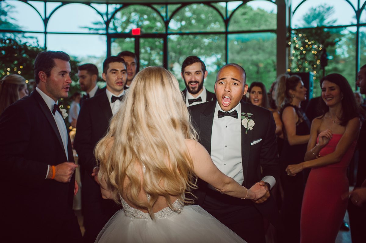 In beautiful Princeton, NJ sits Jasna Polana. This unique wedding venue which is part of TPC Jasna Polana Country Club with it's Tuscany like exterior with cobble stone circular entry way with ground fountain. You'll feel like a royal family when you get married here. It was raining on Hillary and Will's wedding day, so we didn't get to explore the grounds as much as we would have like to but this brave bride Hillary was willing to go out into the rain for outdoor photos on her wedding day. Incredible colors with all the greens, white flowers from the back garden, Hillary's white wedding dress created such a romantic contrast against the deep greens, blues it was such a incredible day. I had such a fun time capturing Hillary and Will on their wedding day at Jasna Polana and can not wait to come back to this gorgeous venue on a dry day to capture more moments. Hillary and Will's Jasna Polana Princeton NJ wedding captured by Karis from Hey Karis NY, NJ, Brooklyn, Hudson Valley and Catskills Wedding and Elopement Photographer.