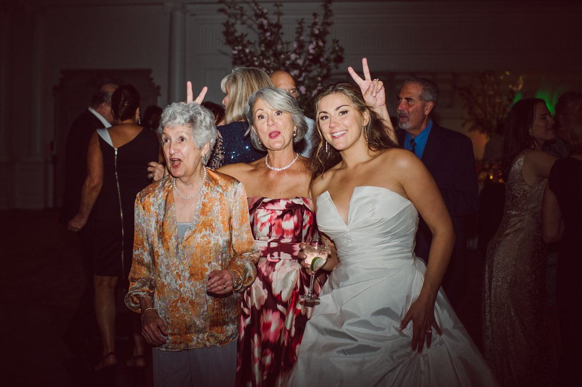 It literally felt like 1000 degrees on Faith and Joe’s wedding at Park Chateau Estate and Gardens. Sun was out and had no plan to hide, not a single cloud in the sky. Despite the gorgeous gardens at Park Chateau Faith and Joe decide to stay cool and alive indoors. I totally don’t blame them, I would much rather be indoor with AC. Thankfully the bridal and groom’s suite at Park Chateau Estate and Gardens is very photogenic with lots of windows. I fully utilized the bridal suite for faith’s getting ready, formal photos with her bridesmaids, first look with her father and her solo photos all before the ceremony. Ceremony was held at the chapel onsite at Park Chateau making everything easy. After the ceremony Faith and Joe did quick few photos outside, some family and group photos then quickly ran indoors before they melted onto the beautiful gardens of Park Chateau. The reception room was filled with peonies and cherry branches it was gorgeous, perfect HOT spring wedding decor. Faith and Joe enjoyed their wedding day the way they wanted by eating drinking and dancing mingling with their guests inside under Cool AC. Faith and Joe’s Park Chateau Estate and Gardens Wedding captured by Karis from Hey Karis NY, NJ, Brooklyn, Hudson Valley and Catskills Wedding and Elopement Photographer.