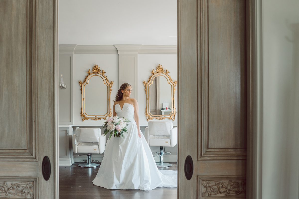 It literally felt like 1000 degrees on Faith and Joe’s wedding at Park Chateau Estate and Gardens. Sun was out and had no plan to hide, not a single cloud in the sky. Despite the gorgeous gardens at Park Chateau Faith and Joe decide to stay cool and alive indoors. I totally don’t blame them, I would much rather be indoor with AC. Thankfully the bridal and groom’s suite at Park Chateau Estate and Gardens is very photogenic with lots of windows. I fully utilized the bridal suite for faith’s getting ready, formal photos with her bridesmaids, first look with her father and her solo photos all before the ceremony. Ceremony was held at the chapel onsite at Park Chateau making everything easy. After the ceremony Faith and Joe did quick few photos outside, some family and group photos then quickly ran indoors before they melted onto the beautiful gardens of Park Chateau. The reception room was filled with peonies and cherry branches it was gorgeous, perfect HOT spring wedding decor. Faith and Joe enjoyed their wedding day the way they wanted by eating drinking and dancing mingling with their guests inside under Cool AC. Faith and Joe’s Park Chateau Estate and Gardens Wedding captured by Karis from Hey Karis NY, NJ, Brooklyn, Hudson Valley and Catskills Wedding and Elopement Photographer.